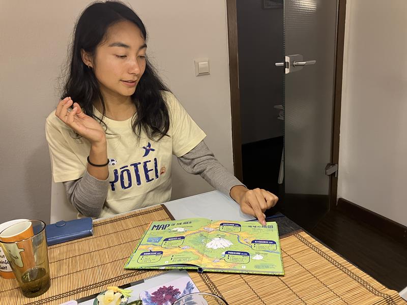 [Maria showing the book]